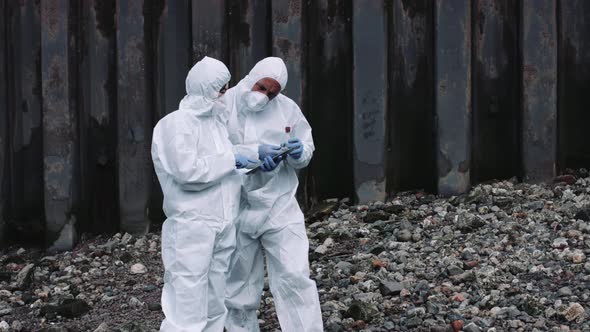 Forensic scientist examining sample at river bank