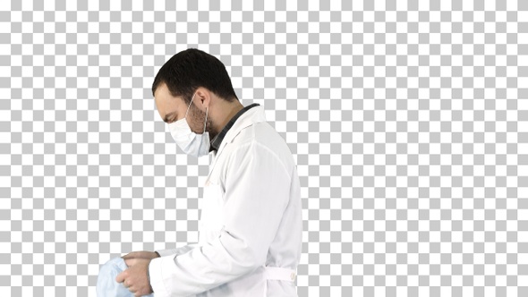 Walking doctor putting on mask and cap, Alpha Channel alt