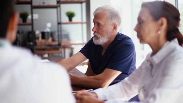 Medical Team of Doctors on Meeting in Medical Office Discussion About Treatment for Patient. alt