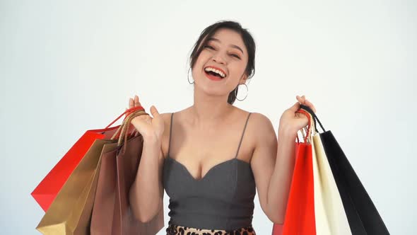 slow-motion of cheerful woman holding shopping bag