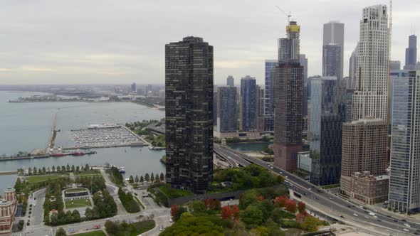 Aerial of high-rise towers, busy street and Lake Michigan in Chicago alt