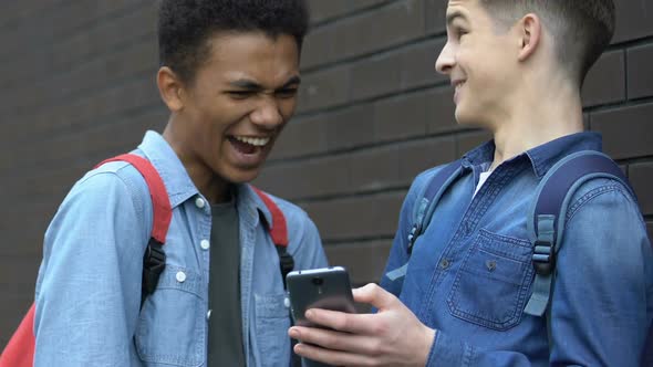 Multiethnic Teens Scrolling Phone and Laughing Forbidden Content Lack of Control alt