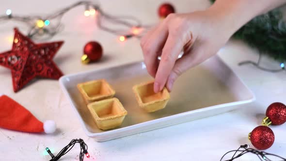 Empty tartlets for starters are put onto the serving plate alt