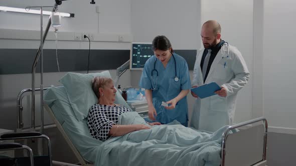 Medical Team Doing Checkup Visit for Aged Patient with Disease alt