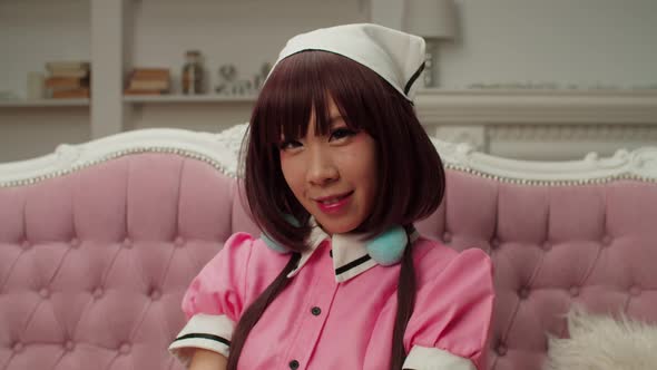 Beauty Portrait of Charming Asian Woman Cosplayer in Anime Costume Smiling alt