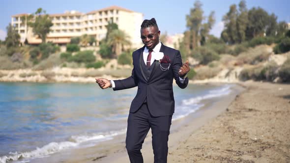 Portrait of Cheerful Excited Happy African American Groom in Elegant Suit Dancing Walking on Sunny alt