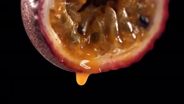 Slow Motion Macro Shot of Flowing Passion Fruit Maracuya Juice From Halved Maracuya alt