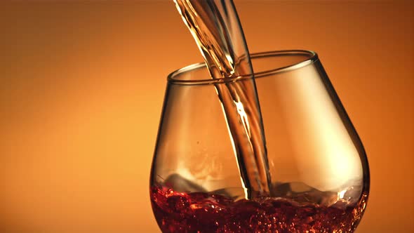 Cognac Flows in a Stream with Air Bubbles Into the Glass alt