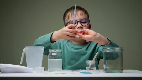 Childhood Scientist Learning in the Chemistry Laboratory. Boy, Student Learning and Doing a Chemical