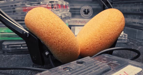 Orange headphones and player with spinning cassette. Player and cassette. alt