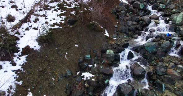 Drone shots of stream and small waterfalls created by melting snow in Troodos Mountain Cyprus. alt