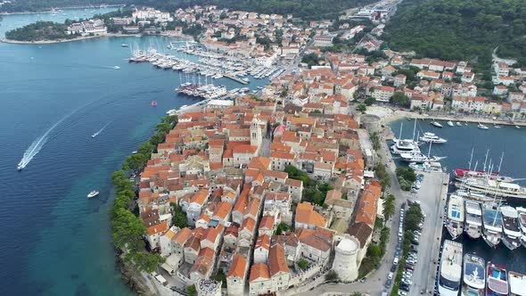 Aerial view of famous Croatian island Korcula, sailing speedboats, yachts and sailboats