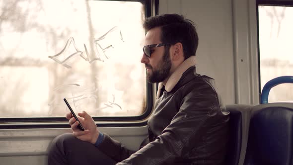 Man Using Smartphone For Online Shopping. Remote Working Public Transport. Sending Message. alt