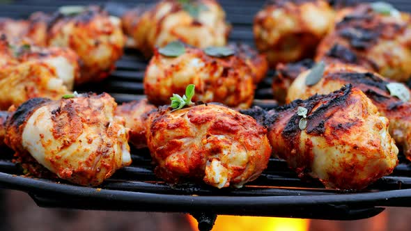 Spicy grilled chicken leg with spices on grill alt