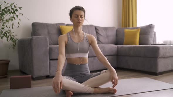 Relaxed and Confident Young Woman Meditating During Quarantine alt