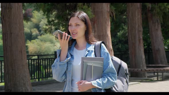 Young Student Girl Talking By the Phone