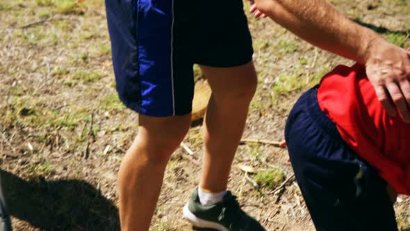 Kids crawling under the net during obstacle course training alt