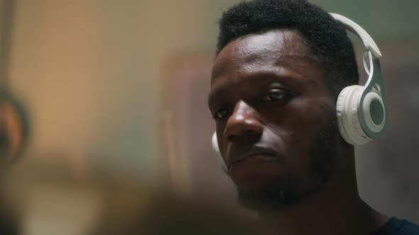Black Guy in Headphones Playing Drums alt