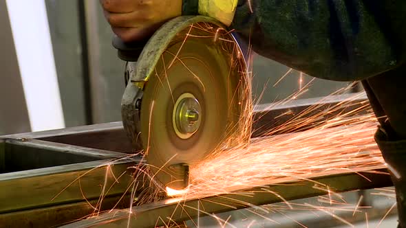 Sparks fly off a grinder in a factory