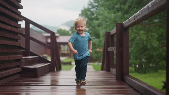 Little Boy Runs to Hug Loving Parent Along Veranda Deck alt