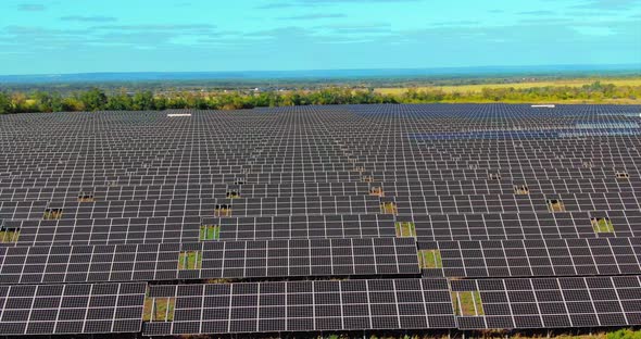 Solar Power Plant Many Solar Cells are Standing in the Field alt