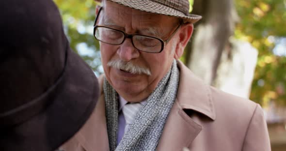 Couple in Love Talking Woman Corrects Male Scarf and They Smiling on Nature alt