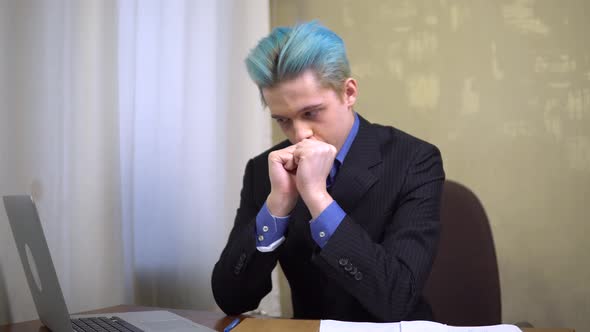 Young Business Man Looking at Laptop with Hope Wating Good News Office Worker