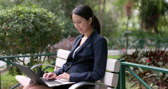 Business woman use of notebook computer at outdoor alt