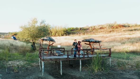 Couple Enjoying a Glass of Wine on a Pontoon in a Rural Are alt