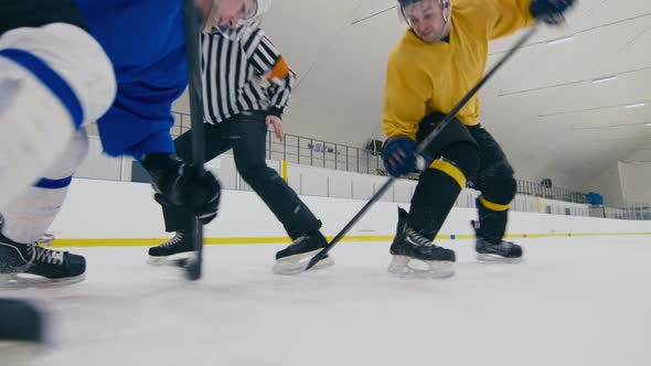 Hockey players fighting for puck after face-off