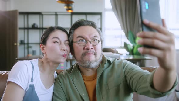 happiness joyful family love concept Asian family holiday activity dad holding smartphone alt