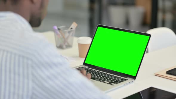 Close Up of African Man Writing on Paper with Pen alt