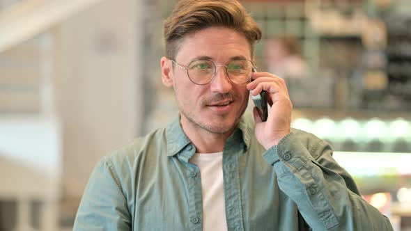 Portrait of Cheerful Middle Aged Man Talking on Smartphone alt