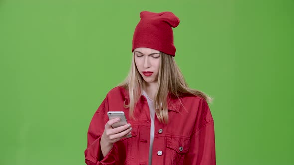 Teenager Prints a Message on the Phone. Green Screen. Slow Motion alt