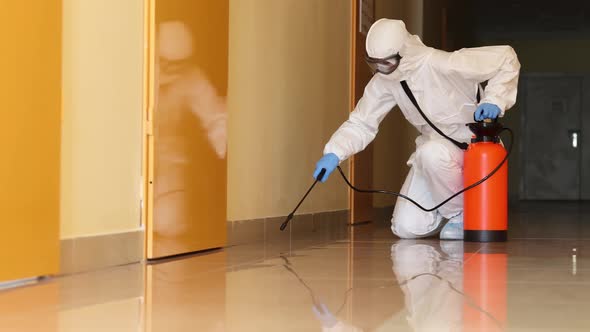 Disinfector in Protective Suit and Respirator Treating Surfaces with Antiseptic in Clinic  Movie alt