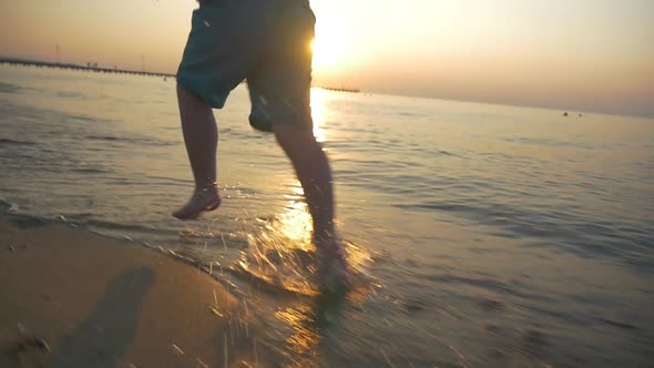 Feet of Boy Running on the Beach alt