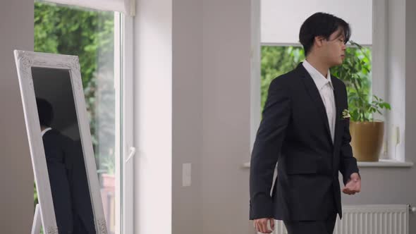 Handsome Confident Asian Groom in Wedding Suit Leaving in Slow Motion Indoors alt