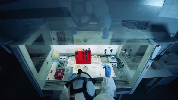 Worker Filling Sample Tube with Liquid While Developing a Vaccine. Coronavirus, COVID-19, 2019-Ncov alt