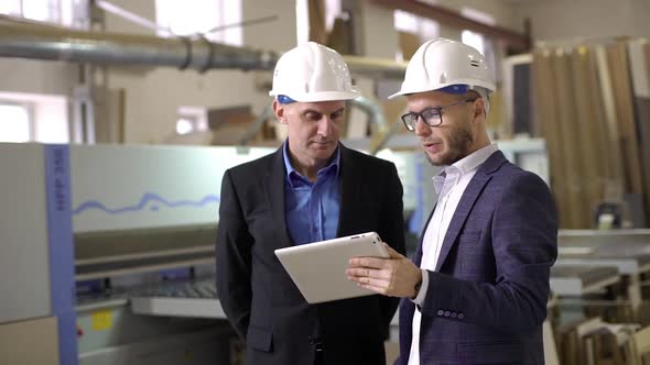 Two Adult Male Executive Manager and Director Discussing Process of Work on Furniture Manufacture alt