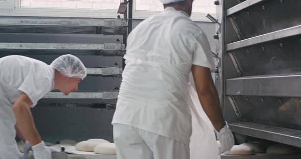 Closeup Two Men Workers Load From the Shelf the alt