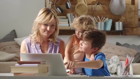 family online shopping by credit card, mother with daughter and son use the computer at home