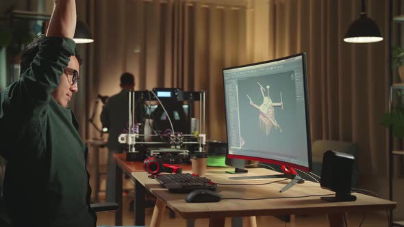Asian Engineer Stretching While Work On Personal Computer And 3D Printer, Screen Shows Cad Software alt