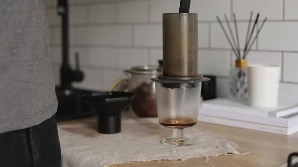 Barista Makes Aeropress Step By Step. Coffee Is Poured By Boiling Water alt