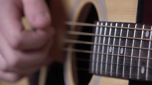 Hand of Man Playing Guitar, Focus on Strings, Close Up alt