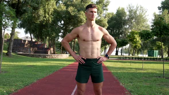 Serious Strong Guy Athlete with Bare Muscular Torso Looking at Sun Before Workout Achievement alt