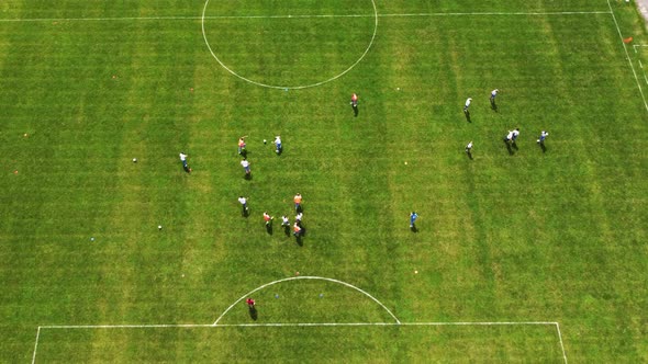 Aerial View From Top To Bottom On A Green Soccer Field. Dynamic Training With The Ball.