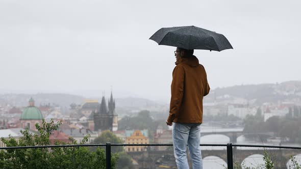 Man With Umbrella During Rain In City