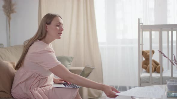 Pregnant Woman Doing Paperwork alt