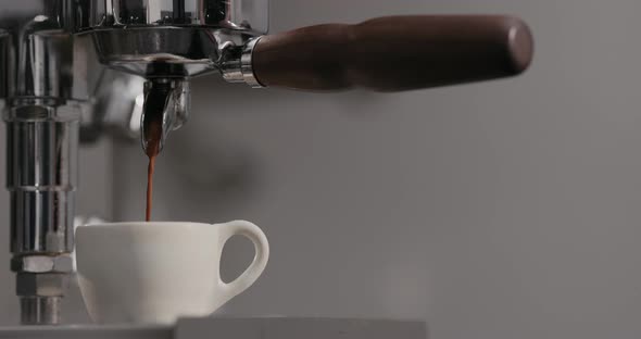 Slow Motion Man Making Espresso with Single Spout Portafilter on Coffee Machine alt