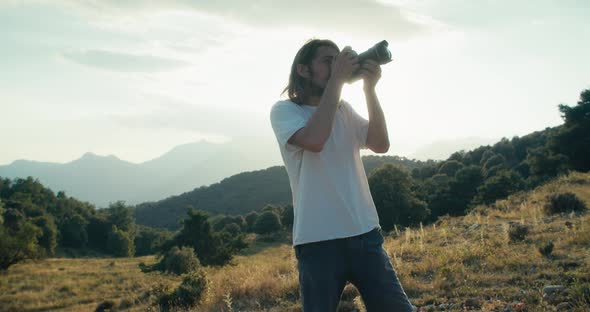 Young Adult Hipster Men Making Picture on Digital Camera on Hike Trip Adventure alt
